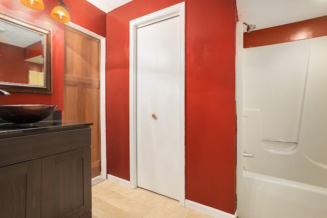 bathroom with shower / tub combination, vanity, and tile patterned flooring