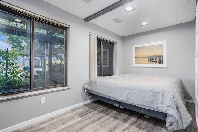 bedroom featuring a textured ceiling and hardwood / wood-style flooring