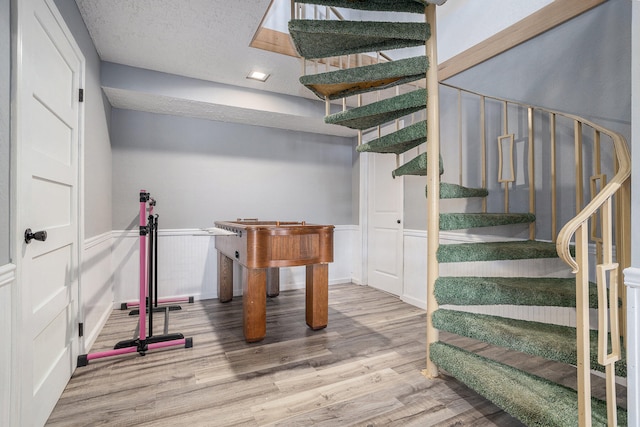 interior space with light hardwood / wood-style flooring and a textured ceiling