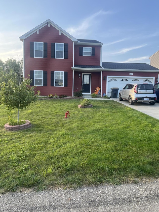 traditional-style home featuring a front lawn, a garage, and driveway