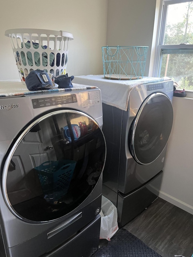 laundry area featuring washer and clothes dryer, laundry area, baseboards, and wood finished floors