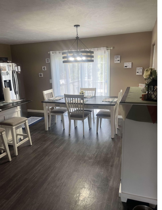 dining area with dark wood finished floors and baseboards