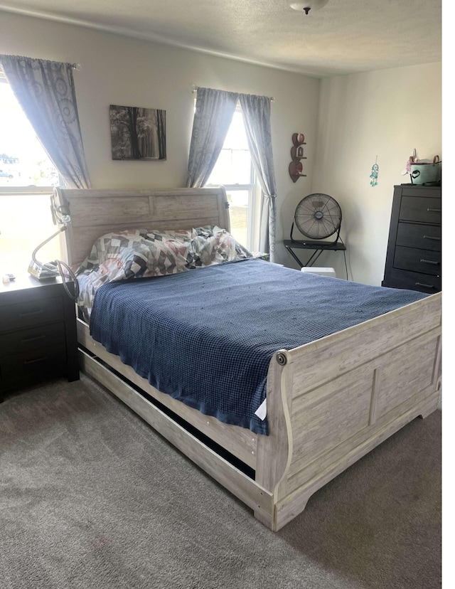 carpeted bedroom featuring a textured ceiling