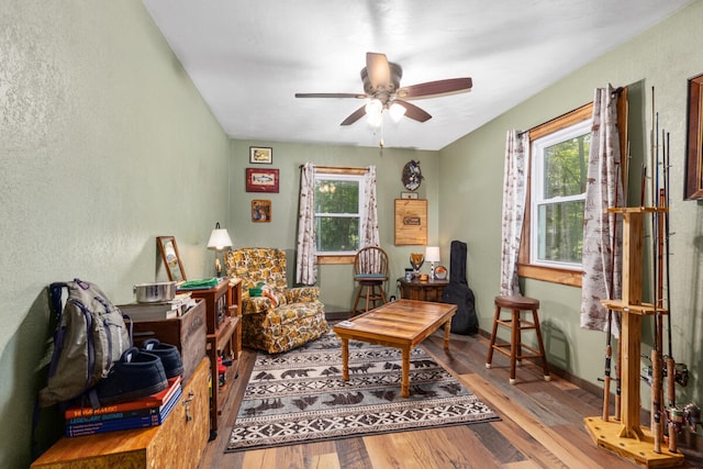 living room featuring ceiling fan, hardwood / wood-style flooring, and a wealth of natural light