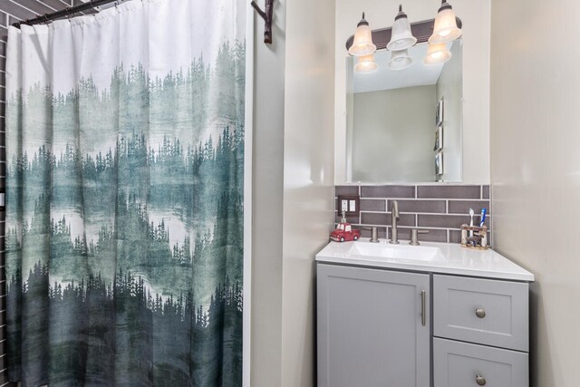 bathroom featuring tasteful backsplash and vanity