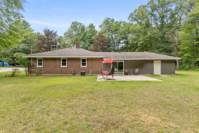 rear view of property with a lawn and a patio area