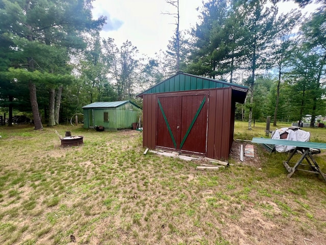 view of shed with an outdoor fire pit