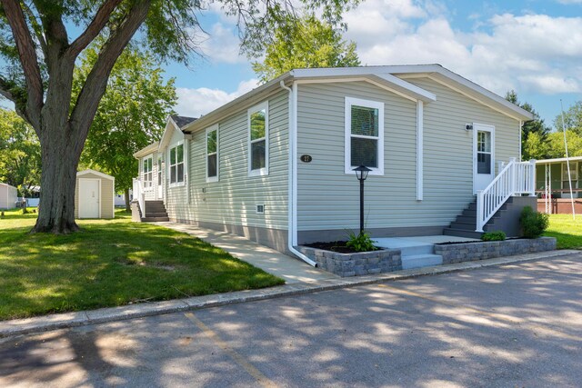 view of front of home with a storage shed