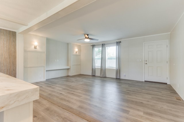 unfurnished living room featuring ceiling fan and light hardwood / wood-style flooring