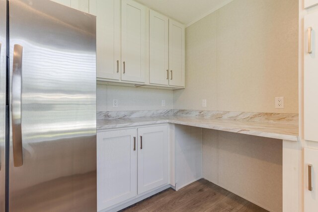 kitchen featuring stainless steel fridge, dark wood-type flooring, and white cabinetry