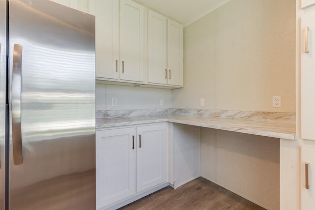 kitchen featuring stainless steel fridge, white cabinets, and dark wood-type flooring