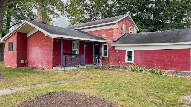 view of front of house with a front lawn and a porch