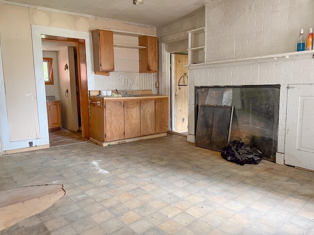 kitchen featuring a fireplace and light tile patterned floors