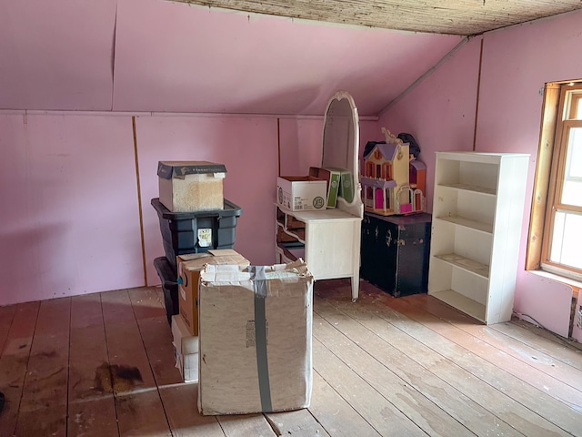 interior space featuring lofted ceiling and wood-type flooring