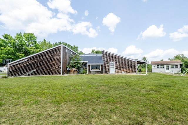 rear view of property with a yard