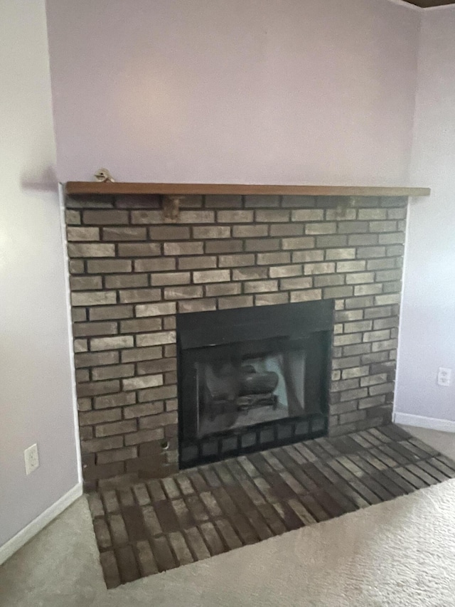 room details featuring a fireplace and baseboards