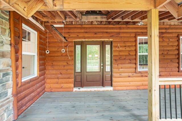 view of exterior entry featuring a deck