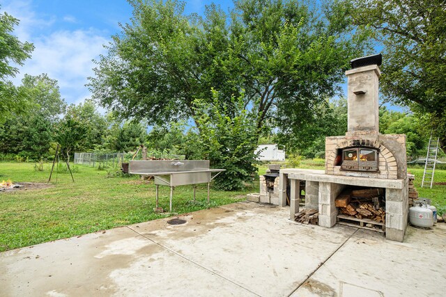 view of patio featuring an outdoor stone fireplace