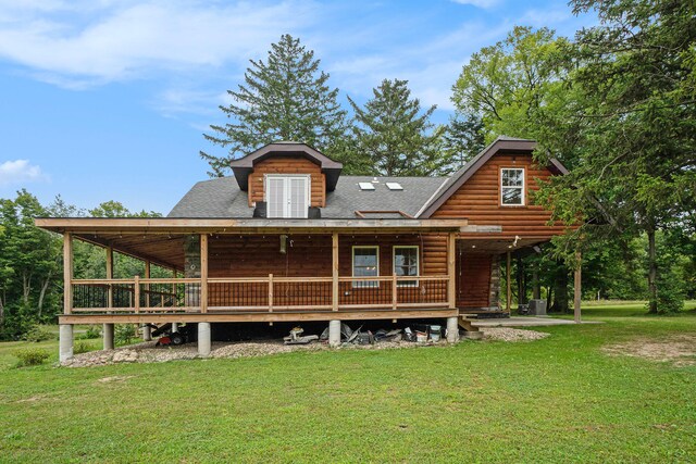 rear view of house featuring a lawn