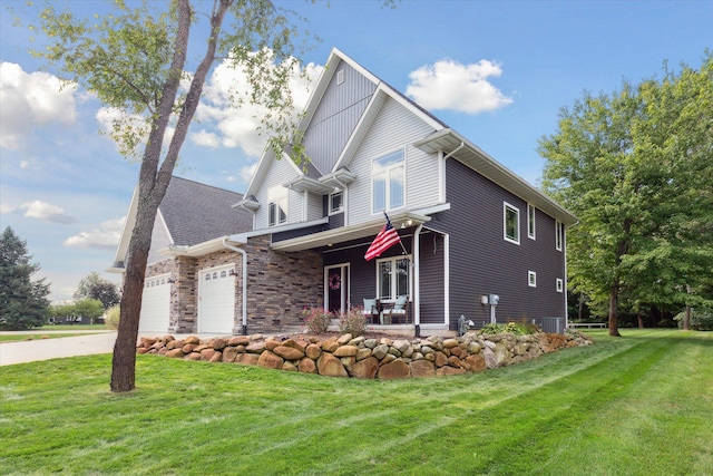 view of front of house with cooling unit, driveway, an attached garage, and a front lawn