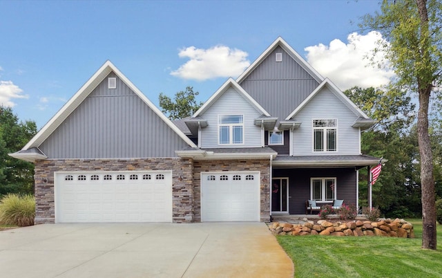 craftsman inspired home with a front lawn, a porch, concrete driveway, an attached garage, and a shingled roof