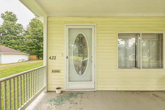 view of exterior entry with a yard