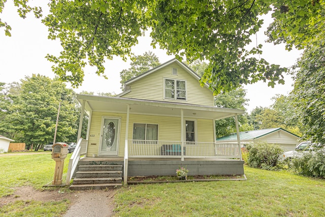 view of front of home with a porch and a front lawn