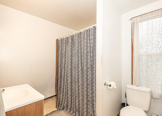 bathroom with tile patterned flooring, toilet, and vanity