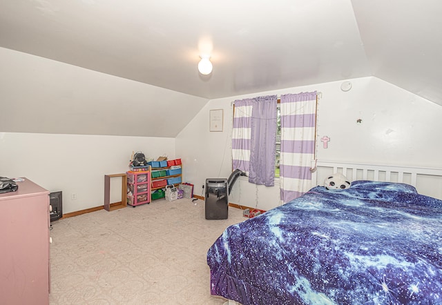 carpeted bedroom with lofted ceiling