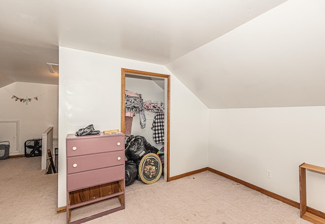 bonus room featuring light colored carpet and vaulted ceiling