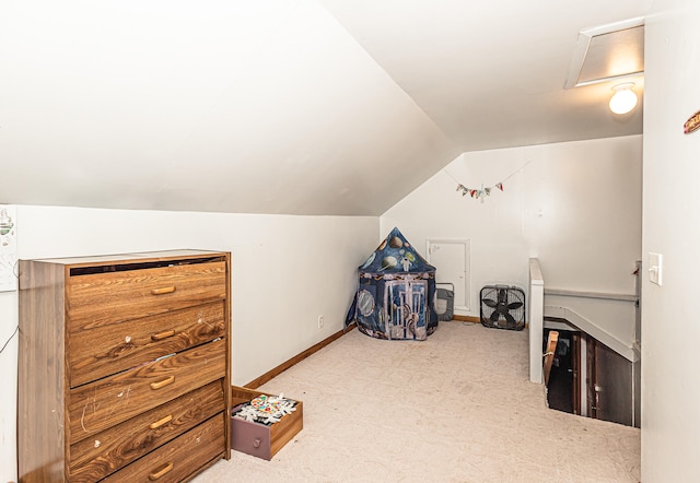 additional living space featuring lofted ceiling and light colored carpet