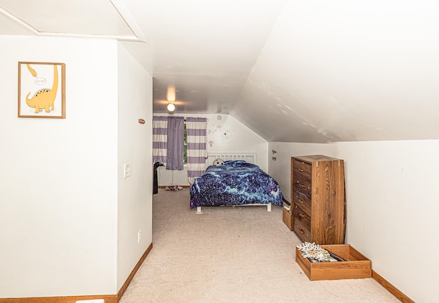 bedroom with carpet flooring and vaulted ceiling