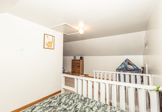 bedroom featuring carpet and vaulted ceiling