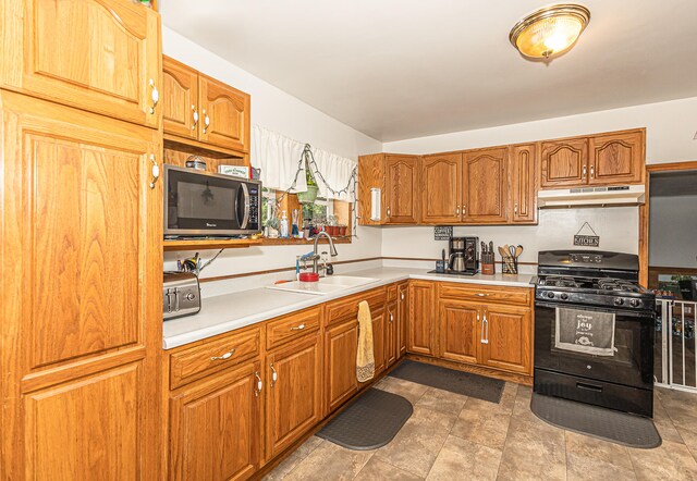 kitchen featuring sink, tile patterned flooring, and black appliances