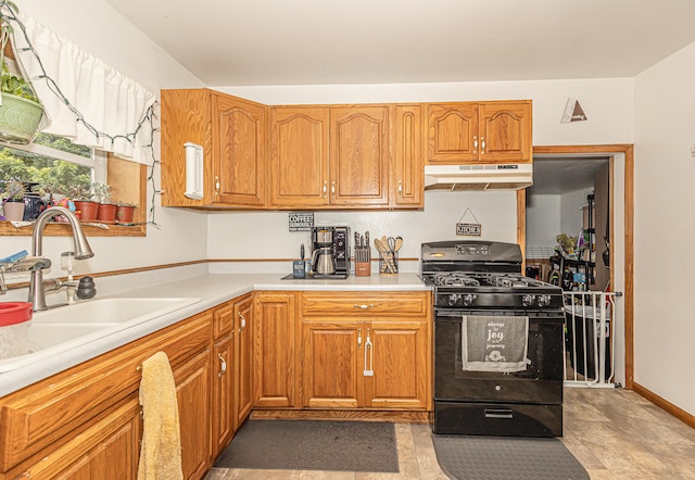 kitchen with sink, light tile patterned flooring, and gas stove