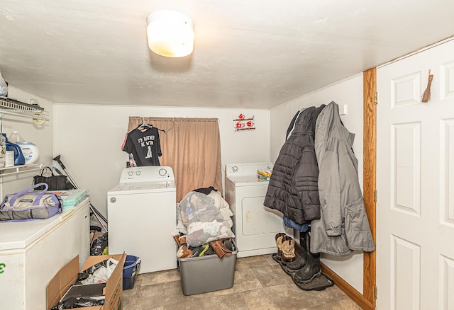 clothes washing area with light tile patterned floors and independent washer and dryer