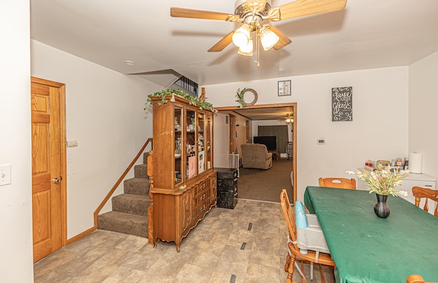 dining room featuring ceiling fan and light colored carpet