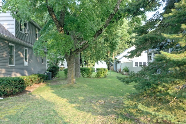 view of yard with central air condition unit