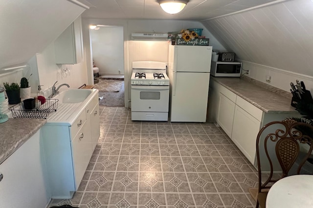 kitchen featuring sink, white appliances, exhaust hood, light tile patterned floors, and lofted ceiling