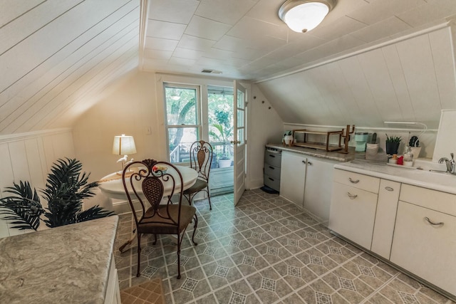 kitchen with vaulted ceiling and tile patterned floors