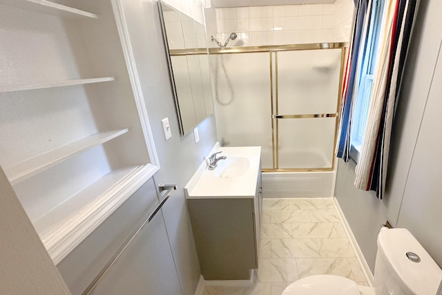 full bathroom featuring tile patterned flooring, combined bath / shower with glass door, toilet, and vanity