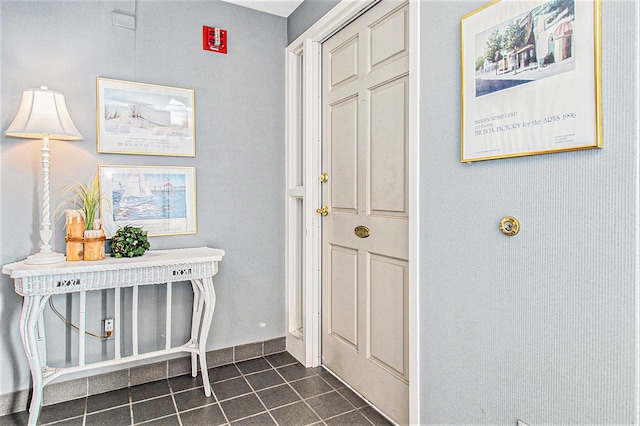 entrance foyer featuring dark tile patterned flooring