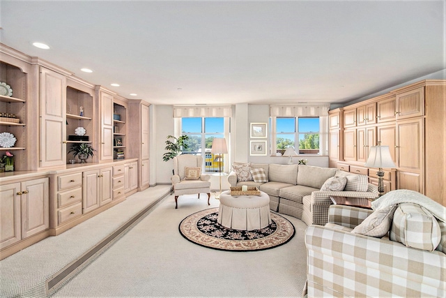 living area featuring recessed lighting and light carpet