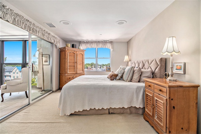 bedroom featuring light carpet and access to exterior