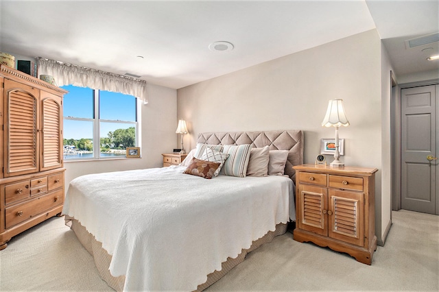 bedroom featuring light colored carpet