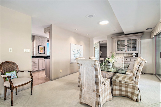 dining space with light colored carpet