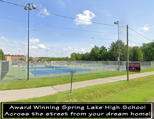 view of sport court with a lawn