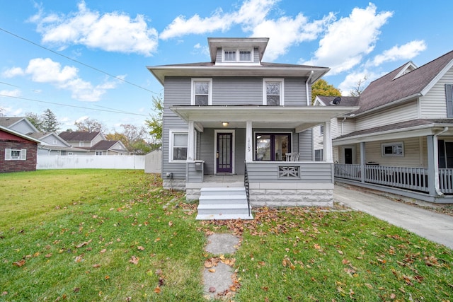 view of front of house featuring a front lawn and covered porch