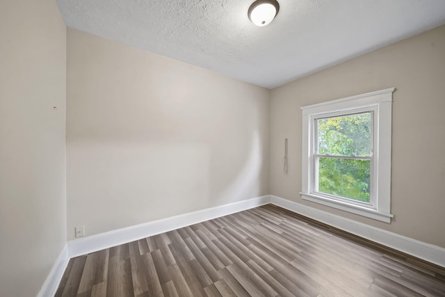 unfurnished room featuring a textured ceiling and hardwood / wood-style flooring