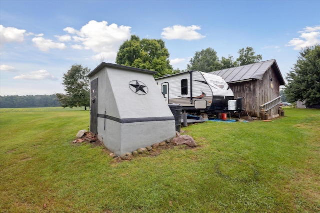 view of outbuilding featuring a lawn